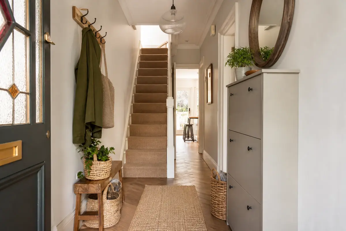 A narrow UK hallway with slim storage and a clear walking route